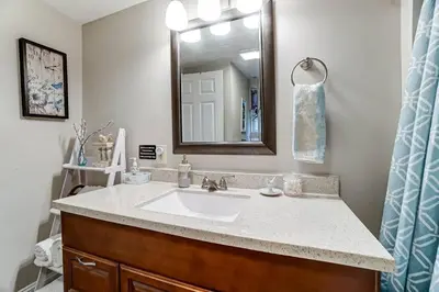 a bathroom with a sink and a mirror at Updated 3bd Cottage on Bike Trail w/ River access! in Loveland