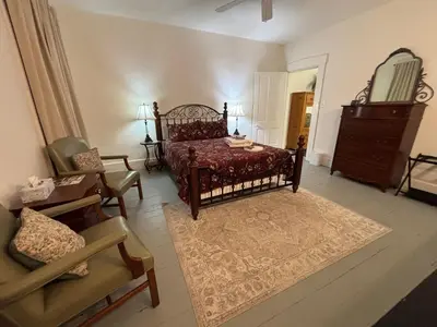 a bedroom with a bed and a chair and a dresser at 