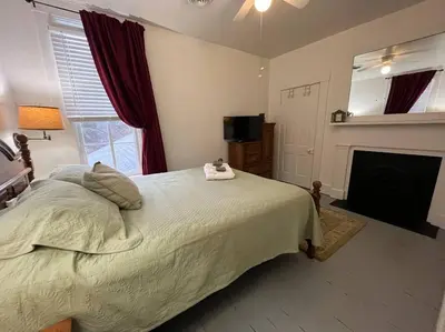 a bedroom with a large bed and a fireplace at 