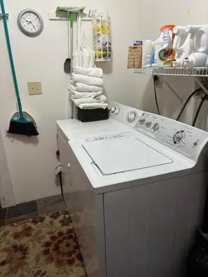 a laundry room with a washing machine and towels at 
