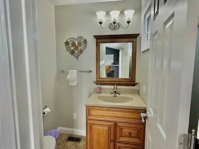 a bathroom with a sink and a mirror at Charming Spacious Get Away in Shelbyville