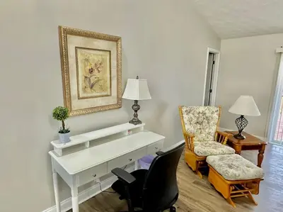 a living room with a white desk and a chair at Charming Spacious Get Away in Shelbyville
