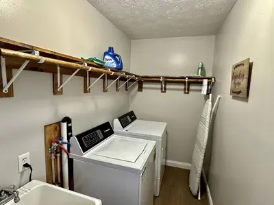 a laundry room with a washing machine and a sink at Charming Spacious Get Away in Shelbyville