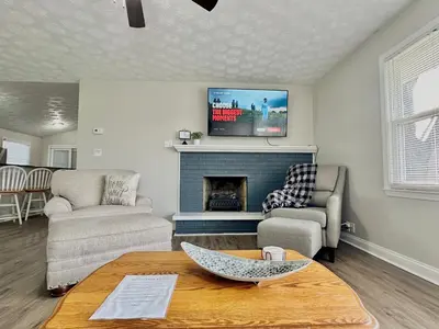 a living room with a fireplace and a tv at Charming Spacious Get Away in Shelbyville