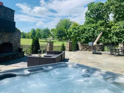a hot tub in a yard with a patio at Beautiful Equestrian Estate home w/ Hot Tub! in Loveland