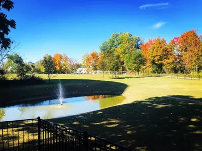 a pond with a fountain in the middle of a park at Beautiful Equestrian Estate home w/ Hot Tub! in Loveland