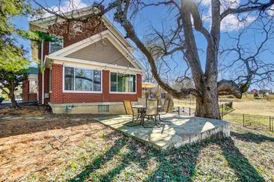 a house with a table and chairs next to a tree at Beautiful Equestrian Estate home w/ Hot Tub! in Loveland