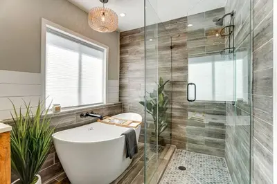 a bathroom with a tub and a glass shower at Beautiful Equestrian Estate home w/ Hot Tub! in Loveland