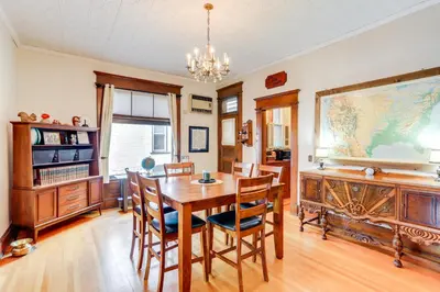 a dining room with a wooden table and chairs at Historic Tiffin Home about Half Mi to University! in Tiffin