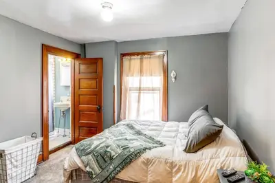 a bedroom with a bed and a bathroom at Historic Tiffin Home about Half Mi to University! in Tiffin