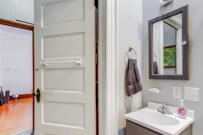 a bathroom with a white sink and a mirror at Historic Tiffin Home about Half Mi to University! in Tiffin
