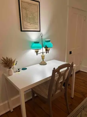 a white table with two lamps and a chair at Madison Manor II by the River Hot Tub Downtown in Madison