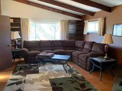a living room with a brown couch and a table at Hidden Treasure in Scott Depot