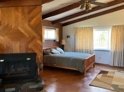 a bedroom with a large bed and a fireplace at Hidden Treasure in Scott Depot