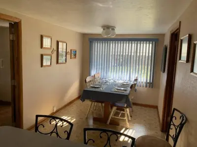 a dining room with a blue table and chairs at Hidden Treasure in Scott Depot