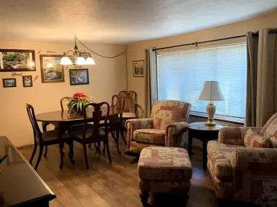 a living room with a table and chairs and a dining room at Hidden Treasure in Scott Depot