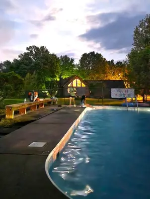 a swimming pool with a house in the background at Hidden Treasure in Scott Depot