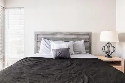 a bedroom with a large bed with a black blanket at Luxury Downtown Townhome Unit 13 in Cleveland