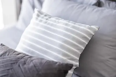 a white and gray pillow sitting on a couch at Luxury Downtown Townhome Unit 13 in Cleveland