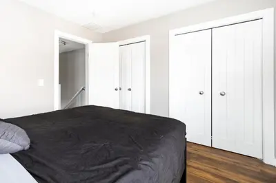 a bedroom with white cabinets and a black bed at Luxury Downtown Townhome Unit 13 in Cleveland