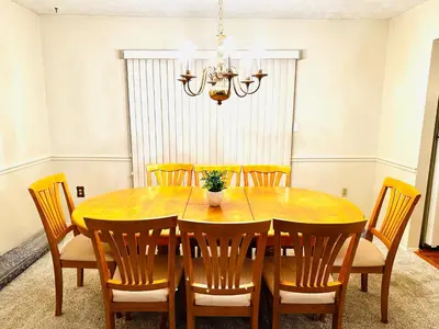 a dining room table with chairs and a chandelier at Ocean Palace -12 Guests- close to I-75-Amazing Location!! in Maud