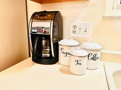 a coffee maker on a counter with three coffee cups at Ocean Palace -12 Guests- close to I-75-Amazing Location!! in Maud