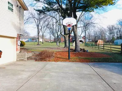 a basketball hoop in a yard next to a house at Ocean Palace -12 Guests- close to I-75-Amazing Location!! in Maud