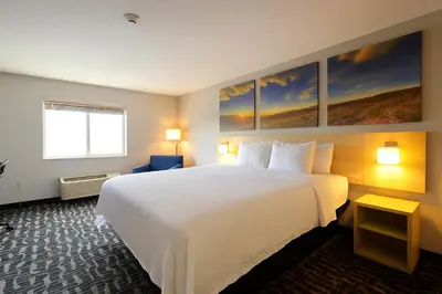 a hotel room with a large white bed and a window at Days Inn by Wyndham Jackson in Jackson