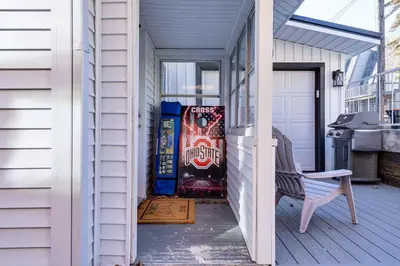 a porch with a bench and a vending machine at Waterfront Buckeye Lake Home with Deck and Dock! in Hebron