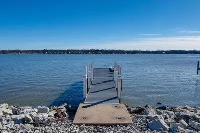 a dock on the shore of a large body of water at Waterfront Buckeye Lake Home with Deck and Dock! in Hebron