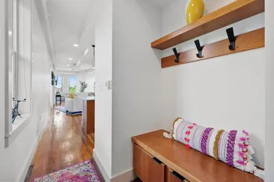 a hallway of a home with white walls and wood floors at Flatiron Bldg - Views - Amazing Cafe - Near to ALL in Cincinnati