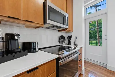 a kitchen with a stove and a microwave at Flatiron Bldg - Views - Amazing Cafe - Near to ALL in Cincinnati