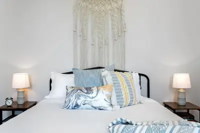 a bedroom with a white bed with pillows and two lamps at Lux 1BR - Amazing Cafe - Views - Located near ALL in Cincinnati