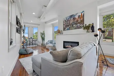 a living room with a couch and a fireplace at Lux 1BR - Amazing Cafe - Views - Located near ALL in Cincinnati