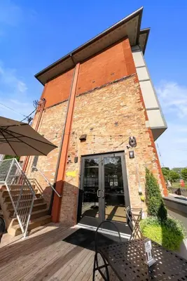 a brick building with a door and a patio at Lux 1BR - Amazing Cafe - Views - Located near ALL in Cincinnati