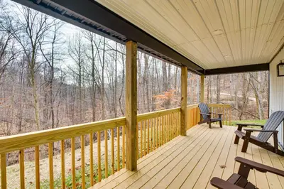 a screened porch with two chairs on it at Modern Salineville Cabin on 13 Acres with Fire Pit! in Salineville