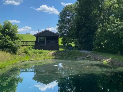 a view of a river with a building in the background at The Mockingbird in Logan