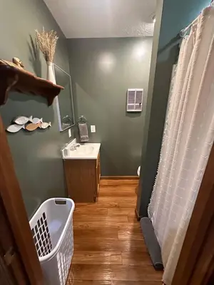 a bathroom with a sink and a mirror and a shower at The Mockingbird in Logan