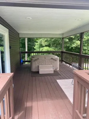 a screened in porch with a couch on a deck at The Mockingbird in Logan
