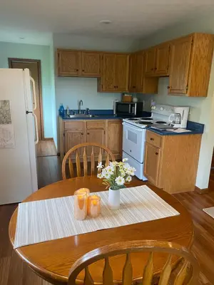 a kitchen with a wooden table with a tableablish at The Mockingbird in Logan