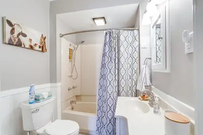 a small bathroom with a toilet and a sink at Cozy Tiffin House with Private Pool 1 Mi to Town! in Tiffin