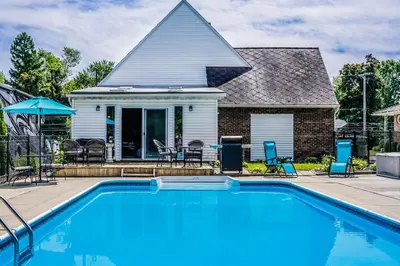 a swimming pool in front of a house at Cozy Tiffin House with Private Pool 1 Mi to Town! in Tiffin
