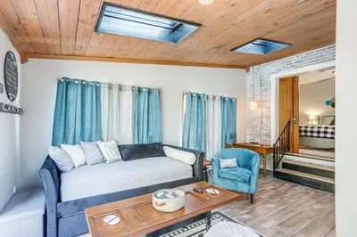 a living room with a bed and a table at Cozy Tiffin House with Private Pool 1 Mi to Town! in Tiffin