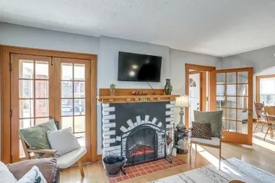 a living room with a fireplace with a tv above it at Cozy Tiffin House with Private Pool 1 Mi to Town! in Tiffin