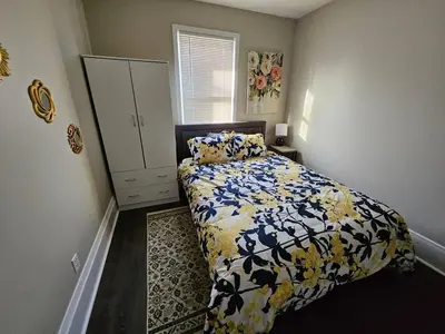 a bedroom with a bed and a dresser in it at Elegant 4 Bed Room at Cleveland Clinic Area in Cleveland