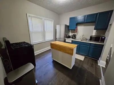 a kitchen with blue cabinets and a counter top at Elegant 4 Bed Room at Cleveland Clinic Area in Cleveland