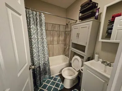 a small bathroom with a toilet and a sink at Elegant 4 Bed Room at Cleveland Clinic Area in Cleveland