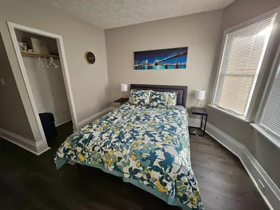 a bedroom with a bed with a floral bedspread at Elegant 4 Bed Room at Cleveland Clinic Area in Cleveland