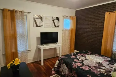 a bedroom with a bed and a tv on a table at Lovely 3 Bed Room in Cleveland in Cleveland Heights