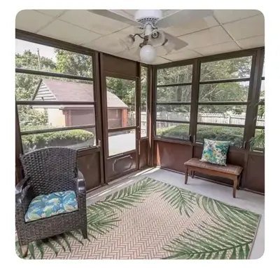 a screened in porch with two chairs and a fan at Private suite near Cleveland Clinic in Shaker Heights
